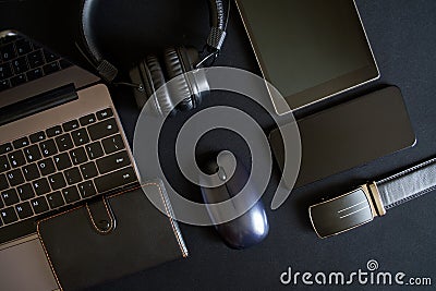 Work accessories of a blogger or office worker lie on a dark background. Laptop, tablet, smartphone, wireless headphones, computer Stock Photo