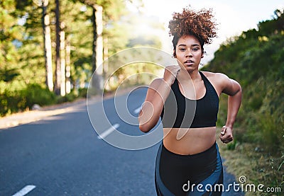 Work on bettering yourself each day. a young woman out for her morning run. Stock Photo