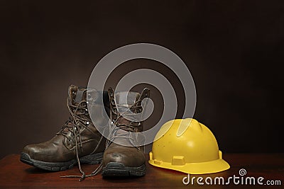 Work Boots and Construction Helmet On Brown With Copy Space Stock Photo