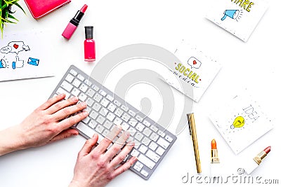 Work desk of beauty blogger with social media icons and cosmetics on white background top view copy space Stock Photo