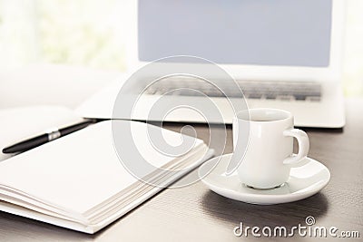 Work desk with a cup of coffee computer laptop, notebook, pen Stock Photo