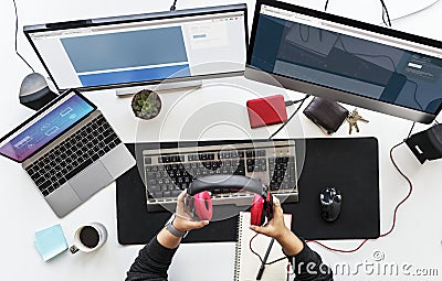 Work desk with multiple screens and electronic devices. Stock Photo