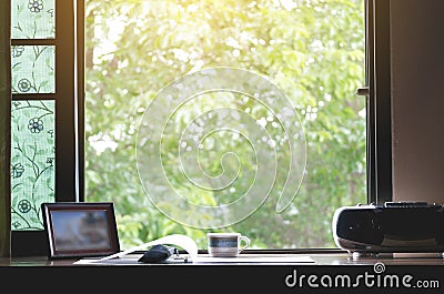 A work desk with a natural atmosphere outside the window with the morning sun Stock Photo