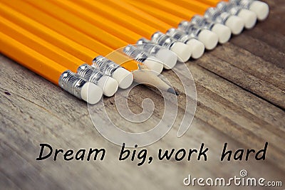 Work hard dream big motivational education message. Rustic wooden background with yellow pencils. Stock Photo