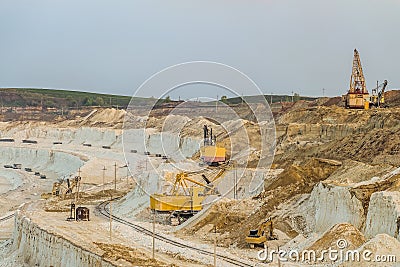 Work of heavy grab and bucket excavators in the chalk quarry Stock Photo