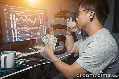 Lifestyle of young trader holding USD dollar trading money exchange with crypto blockchain online Stock Photo