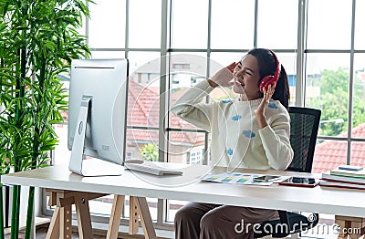 Work from home and online learning or meeting concept. Pretty young women working on computer using smartphone in the living room Stock Photo