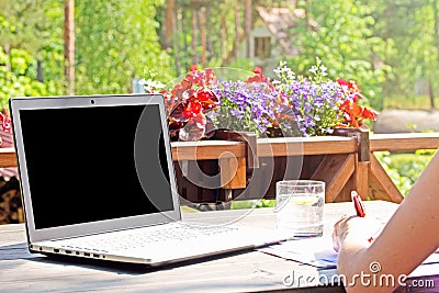 Work from home, table with laptop on terrace Stock Photo