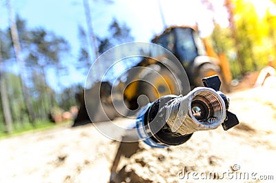 The work of a large two-wheeled tractor when laying water supply for water supply of private homes. the concept of building a coun Stock Photo