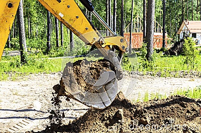 Work of a large two-wheeled tractor when laying water supply for water supply of private homes. the concept of building a country Stock Photo