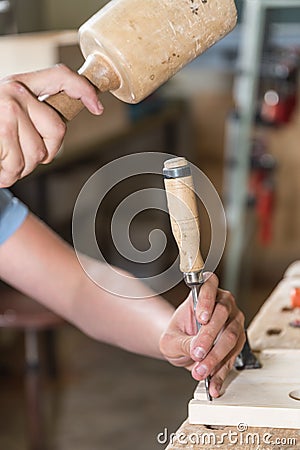 Work with mallet and chisel wood Stock Photo