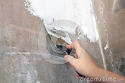 Work plasterer, dirty spatula in hand painter, close-up. Stock Photo