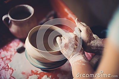 Work in a pottery workshop, womans hands creating ceramics. Stock Photo