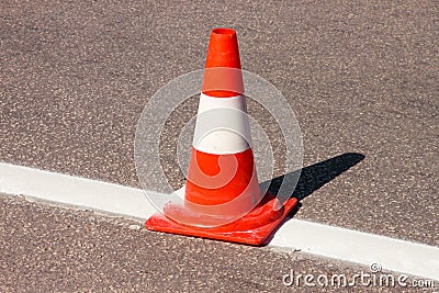 Work on road. Construction cone. Traffic cone, with white and orange stripes on asphalt. Street and traffic signs for signaling. Stock Photo