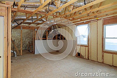 Work site of installing thermal foam polyurea insulation under the roof wool panels and wooden planks Stock Photo