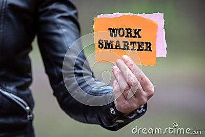 WORK SMARTER. Text on the sheet in hand Stock Photo