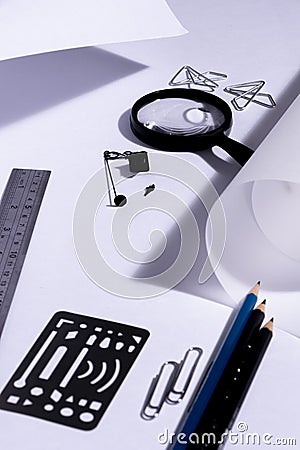 Work table of an architect with blank paper, magnifying glass, ruler, pencils, pens and clips. Architect ready to start work. In b Stock Photo