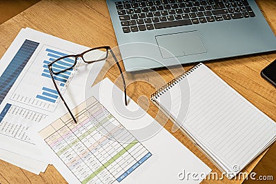 Work table at home with pen, papers, bills, charts, glasses, computer and calculator. Concept work at home, checking accounts, Stock Photo