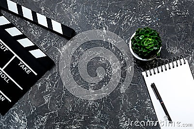 Work table of producer. Movie clapperboard and notebook on grey stone background top view copyspace Stock Photo