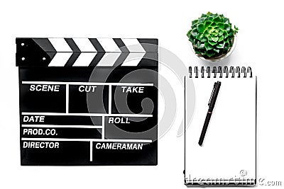 Work table of producer. Movie clapperboard and notebook on white background top view Stock Photo