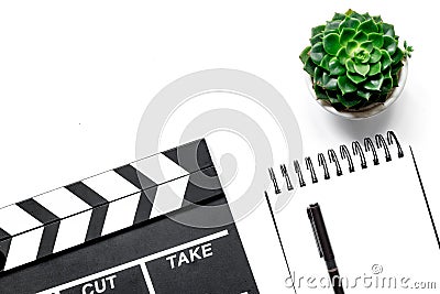 Work table of producer. Movie clapperboard and notebook on white background top view copyspace Stock Photo