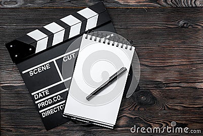 Work table of producer. Movie clapperboard and notebook on wooden table background top view copyspace Stock Photo