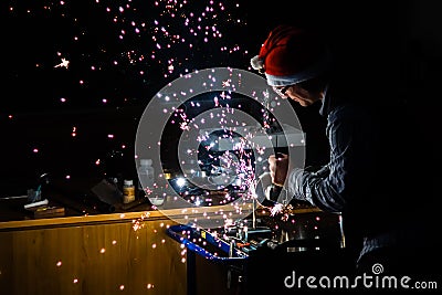 Work on Titanium with angle Grinder and a xmas beanie... Editorial Stock Photo