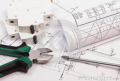 Work tools, electric fuse and rolls of diagrams on construction drawing of house Stock Photo