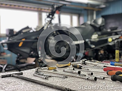 Work tools on table. Service snow snowmobile in the service center. Winter adventures on intro. Surgut, Russia - 24 October 2021. Editorial Stock Photo