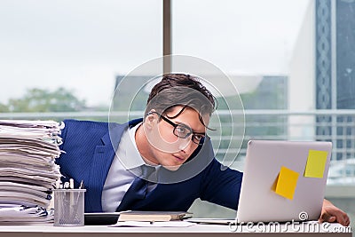 Workaholic businessman overworked with too much work in office Stock Photo