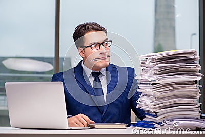 The workaholic businessman overworked with too much work in office Stock Photo