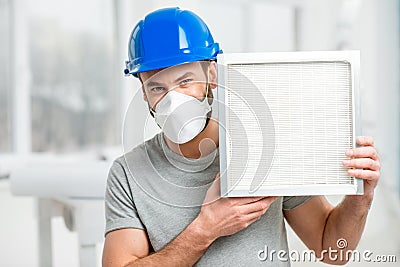 Worker with air filter Stock Photo