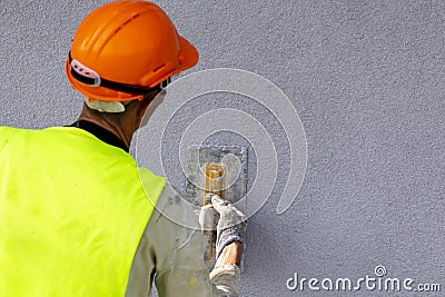 Worker applying decorative plaster on wall Editorial Stock Photo