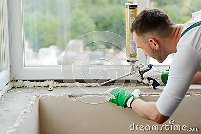 Worker is applying polyurethane foam Stock Photo