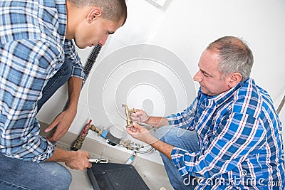 Worker and apprentice checking heating system Stock Photo
