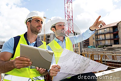 Worker and architect watching some details on a construction Stock Photo