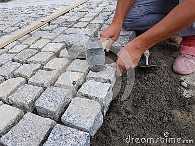 Worker Arranging a Pavement on a Street Stock Photo