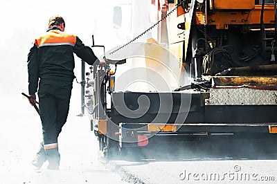 Worker at asphalting works Stock Photo