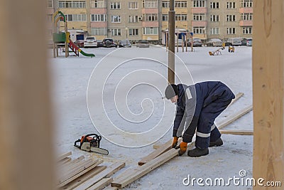 Worker assembling the frame of a wooden slide Stock Photo