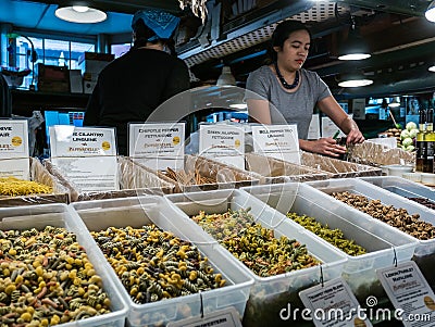Worker behind pasta display, Pike Place Public Market, Seattle Editorial Stock Photo