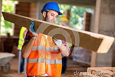 Worker bring construction timber Stock Photo