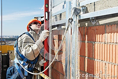 Worker builder at facade construction works Stock Photo
