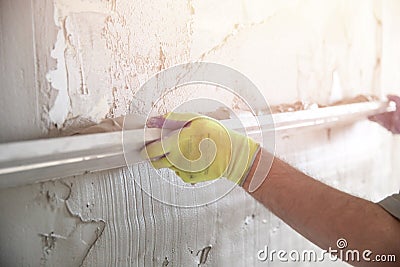 Worker builder hand applied gypsum plaster to smooth surface. Apartment repair concept Stock Photo