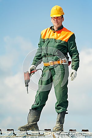 Worker builder roofer at metal profile work Stock Photo