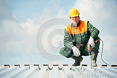 Worker builder roofer at metal profile work Stock Photo