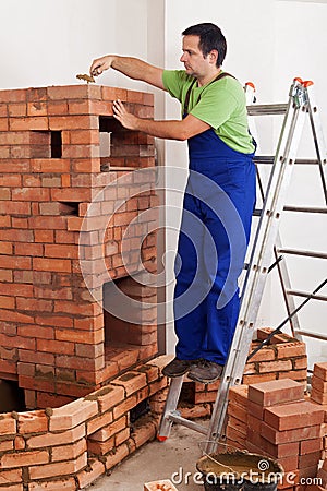 Worker building masonry heater Stock Photo