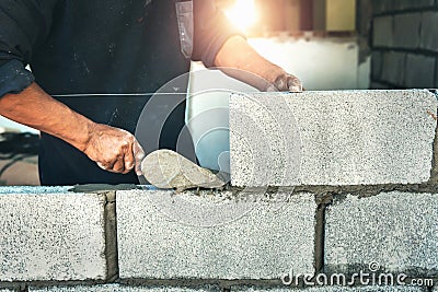 Worker building wall bricks Stock Photo