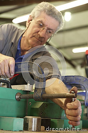 Worker and clamps Stock Photo