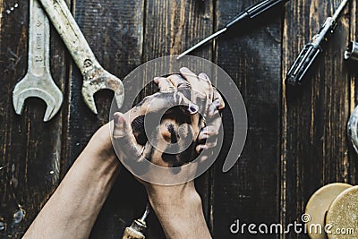 Worker class person dirty dark hands on the wooden table with tools equipment f Stock Photo