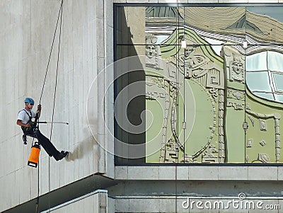 Worker clean the building wall Editorial Stock Photo